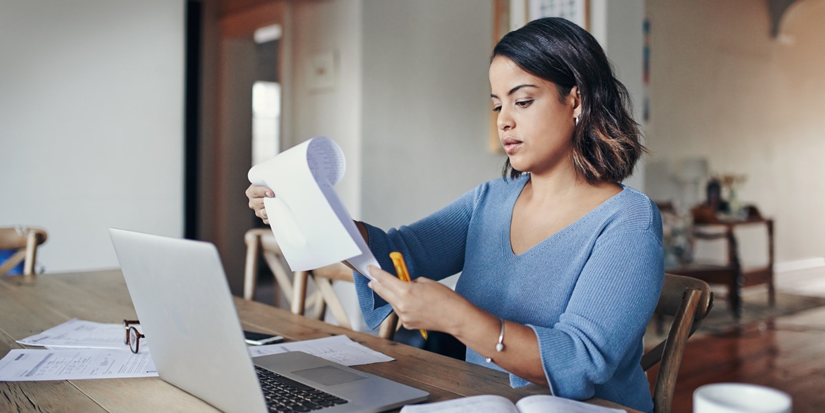 woman working from home, looking through paper files