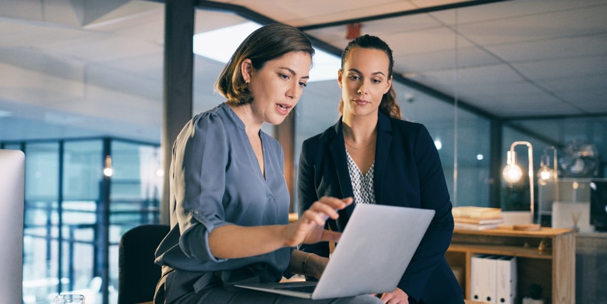 two women in the office looking at computer