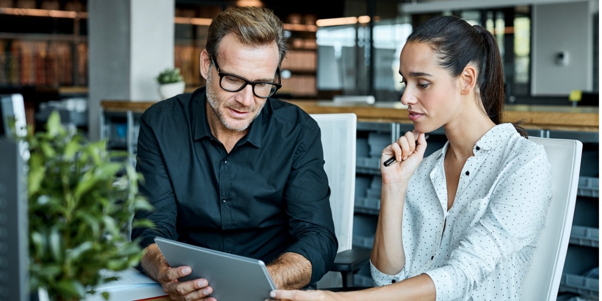 two business people working together on a laptop